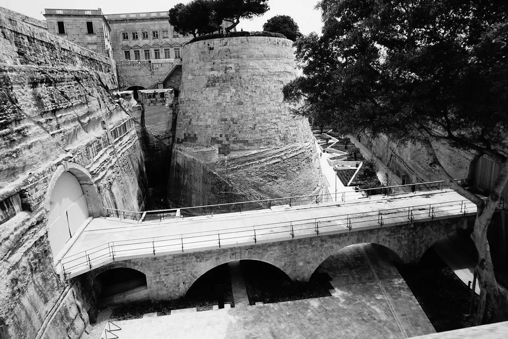 Old bastion walls and a bridge near Valletta's City Gate.