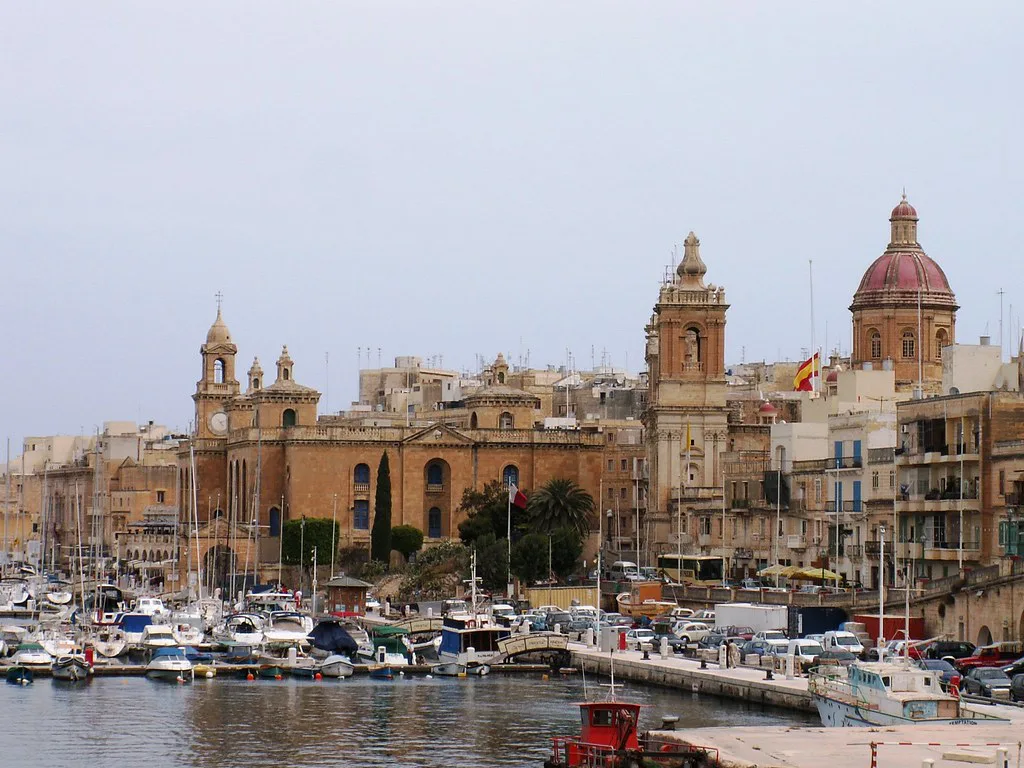 Boats moored in Birgu with St Lawrence Church behind.