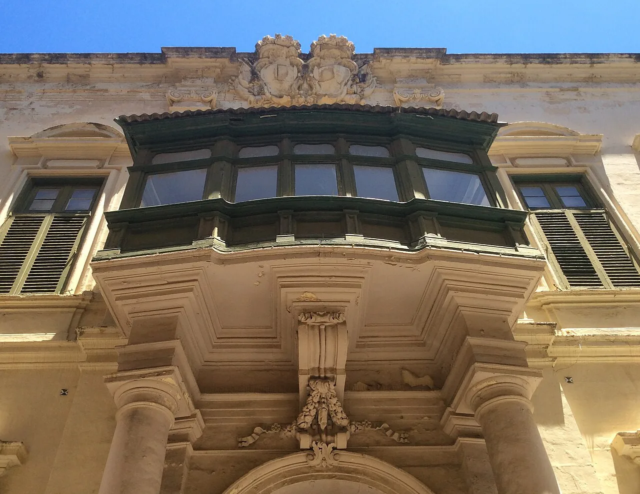 A traditional wooden balcony on Triq Melita in Valletta.