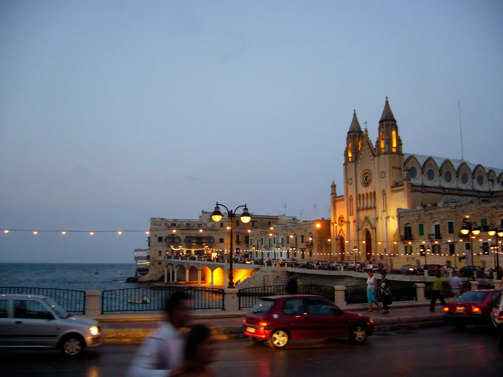 Balluta Bay and the parish church at dusk.