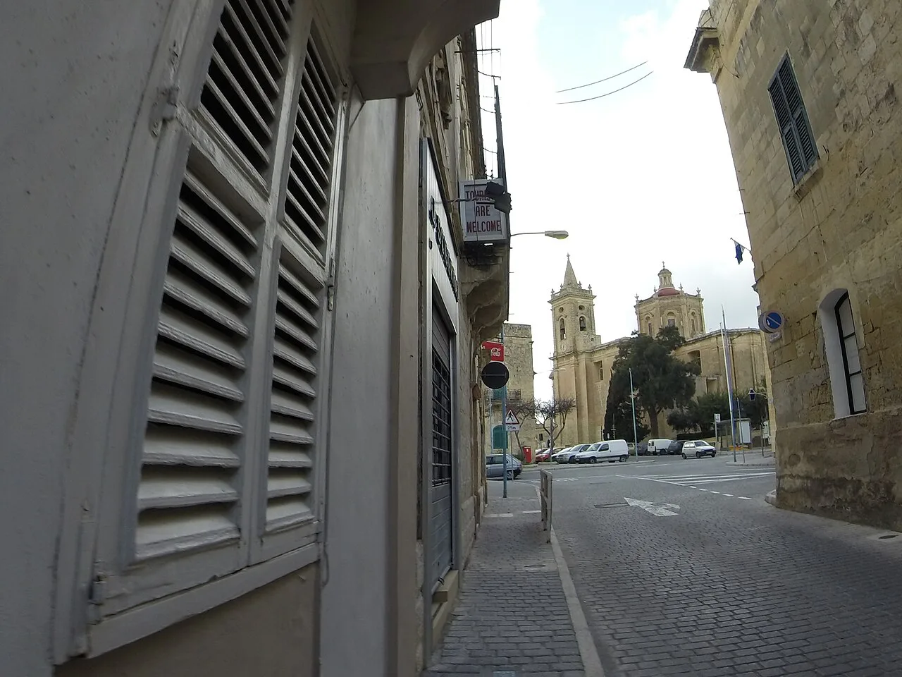 A street in Balzan with the parish church in the distance.
