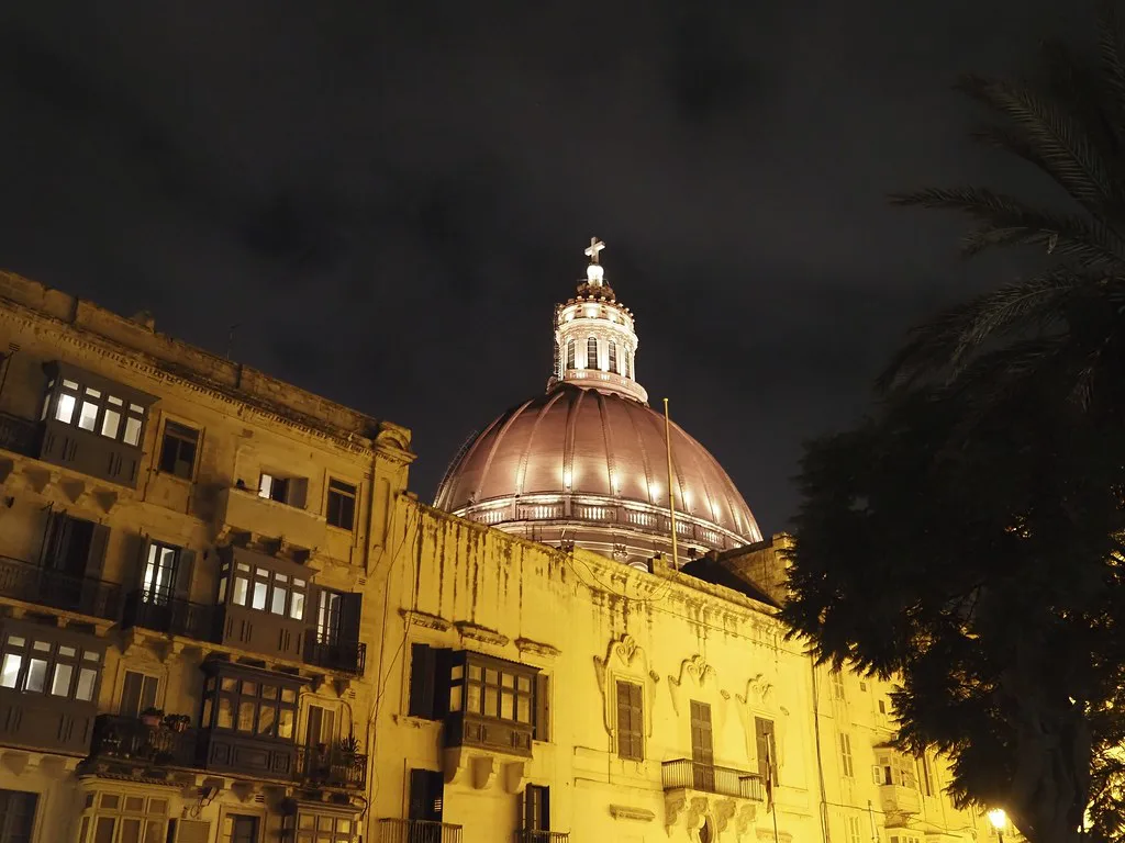 The dome of the Basilica of Our Lady of Mount Carmel in Valletta lit at night.