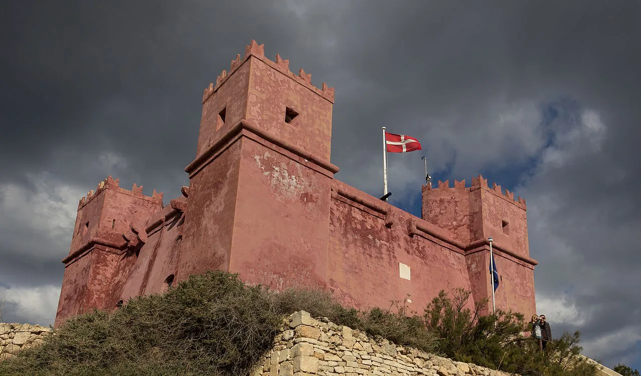 The Red Tower in Mellieħa under a stormy sky.