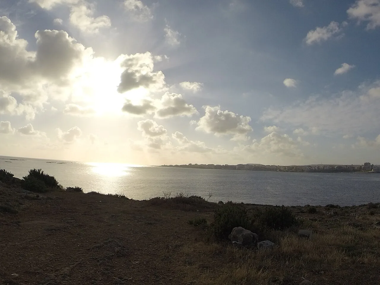 The sun low over the coast at Mistra, St Paul's Bay.