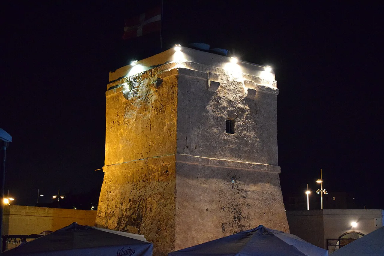 Qawra Point Tower lit up at night.