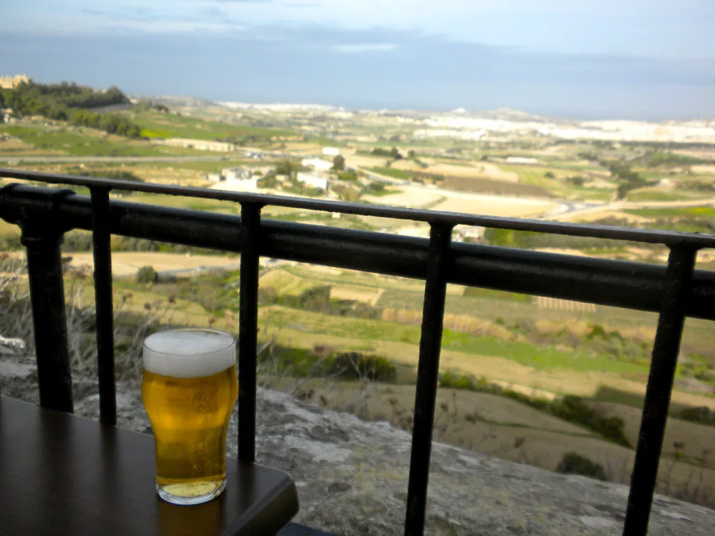 A glass of beer overlooking the countryside from Mdina.