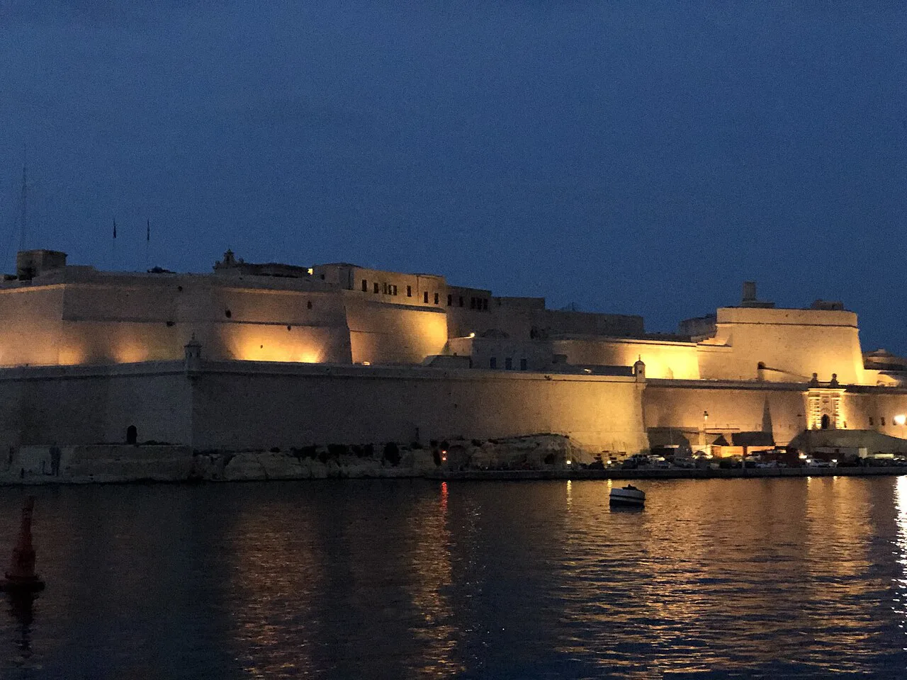 Fort St Angelo in Birgu lit up at dusk.