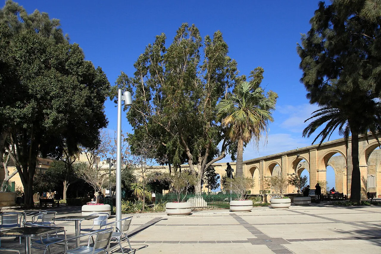 Trees and the arcade of the Upper Barrakka Gardens in Valletta.