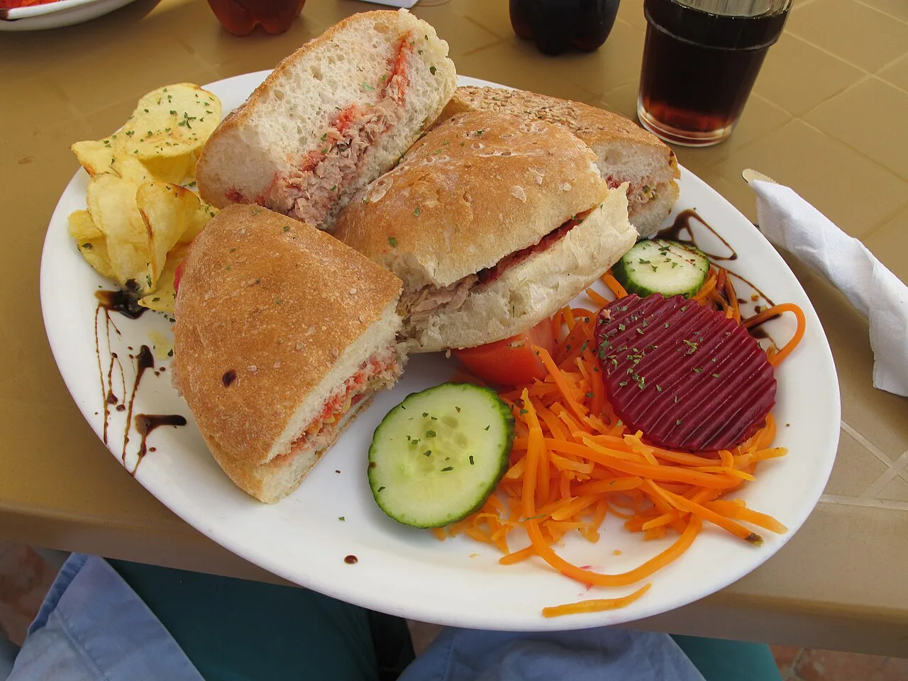 A ftira sandwich served with salad.