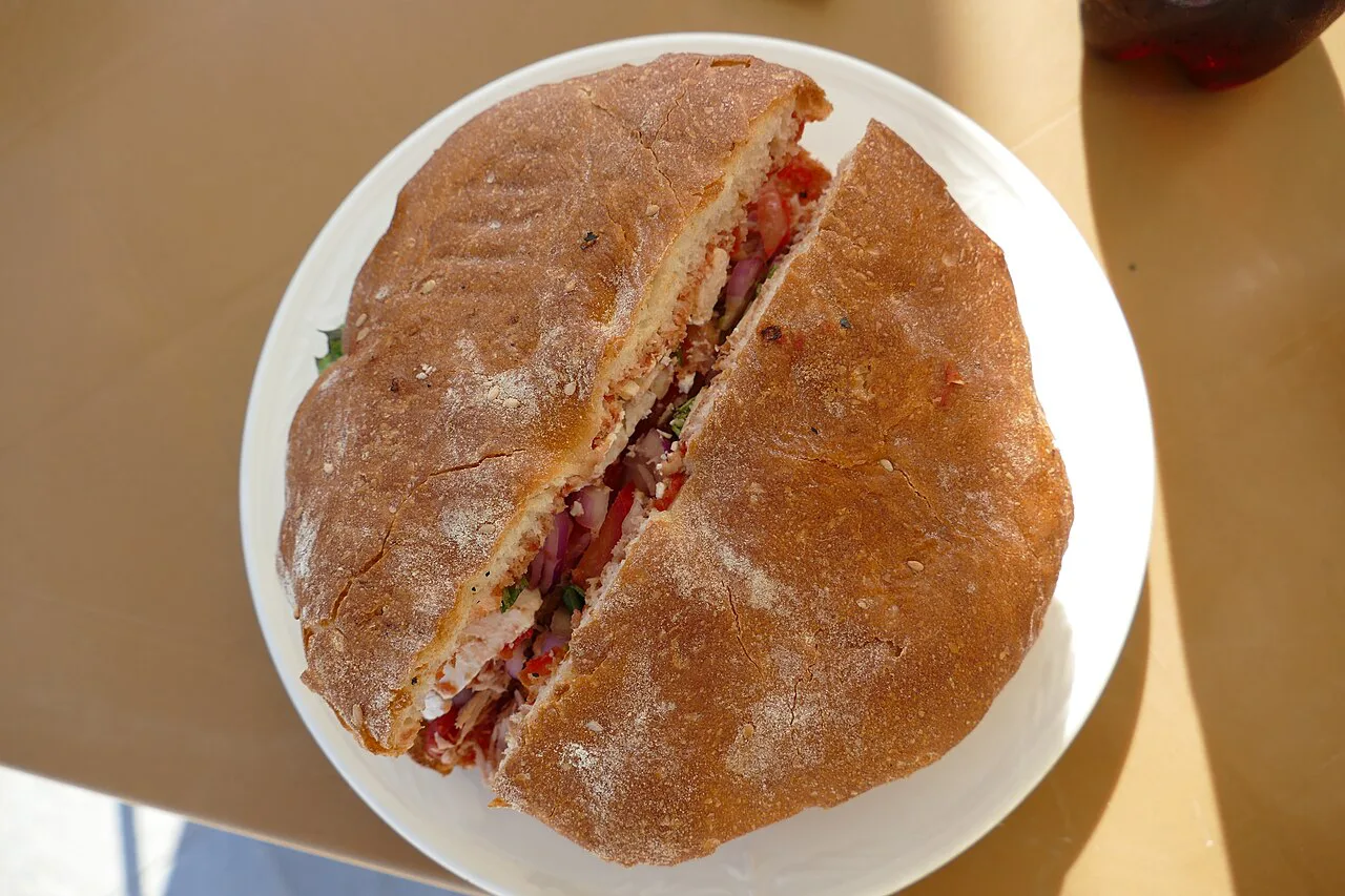 A ftira sandwich filled with tuna.