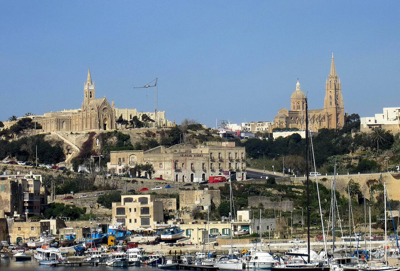 Għajnsielem and the harbour at Mġarr, Gozo, with the churches above.