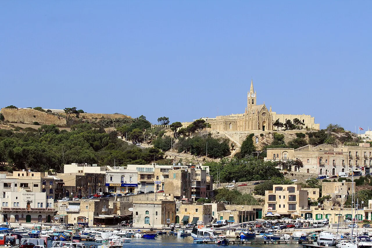 The village of Għajnsielem on Gozo, with its church above the harbour.