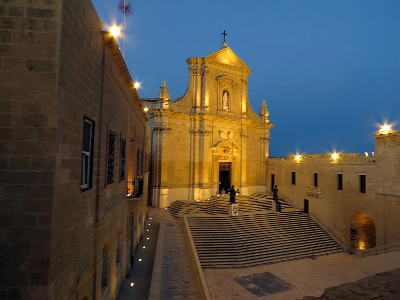 The Cathedral of the Assumption lit up at dusk in Victoria, Gozo.