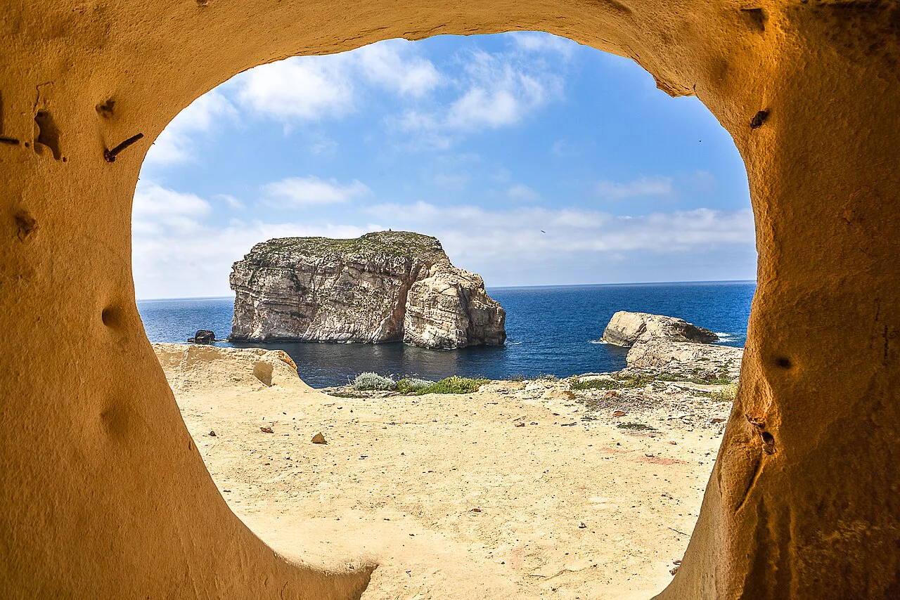 Fungus Rock framed by a cave opening at Dwejra, Gozo.