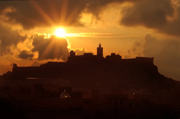 The Cittadella of Victoria silhouetted at sunset in Gozo.
