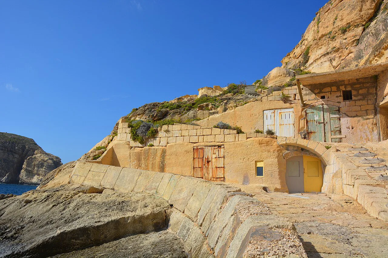 Rock-cut dwellings by the boat ramp at Dwejra, Gozo.