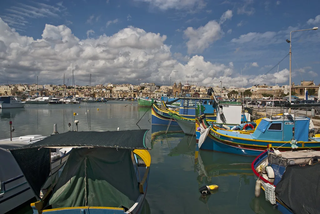 Luzzu boats and the waterfront of Marsaxlokk.