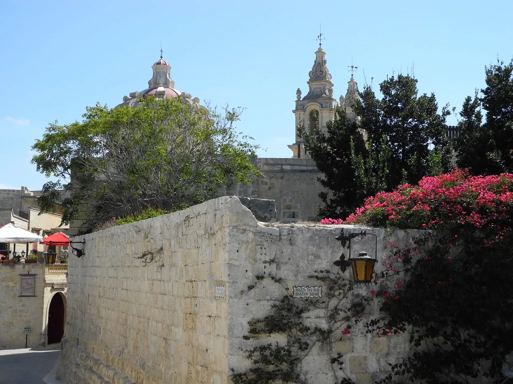 A stone wall and church domes in Mdina.