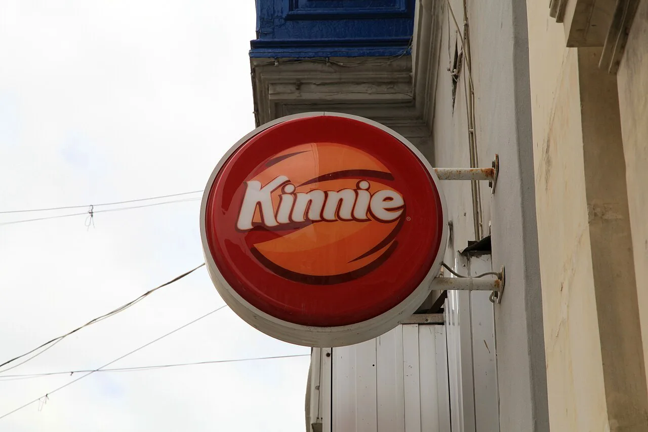 A Kinnie sign on a street in Mosta.