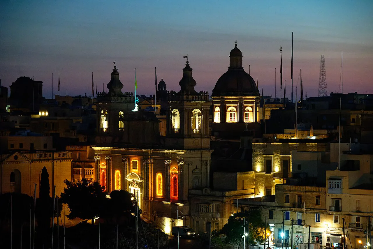 Birgu's St Lawrence Church lit up at dusk.