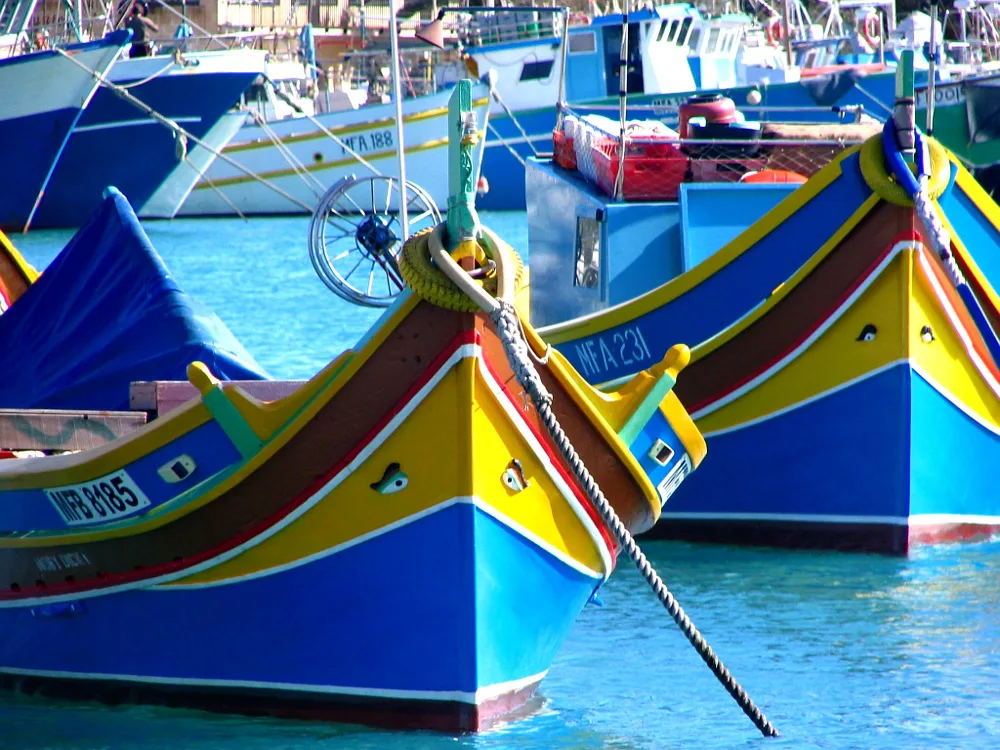 Colourful luzzu boats moored in Marsaxlokk.