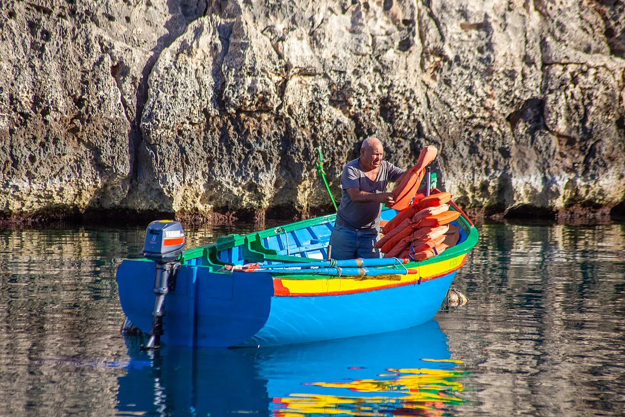 A boat at Wied iż-Żurrieq loaded with life jackets for Blue Grotto trips.