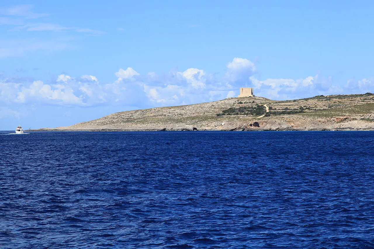 Comino and St Mary's Tower seen from the water.