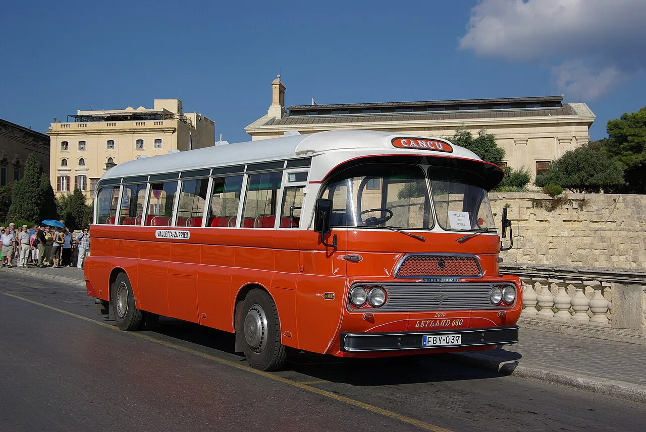 A vintage Malta bus passing through Valletta.