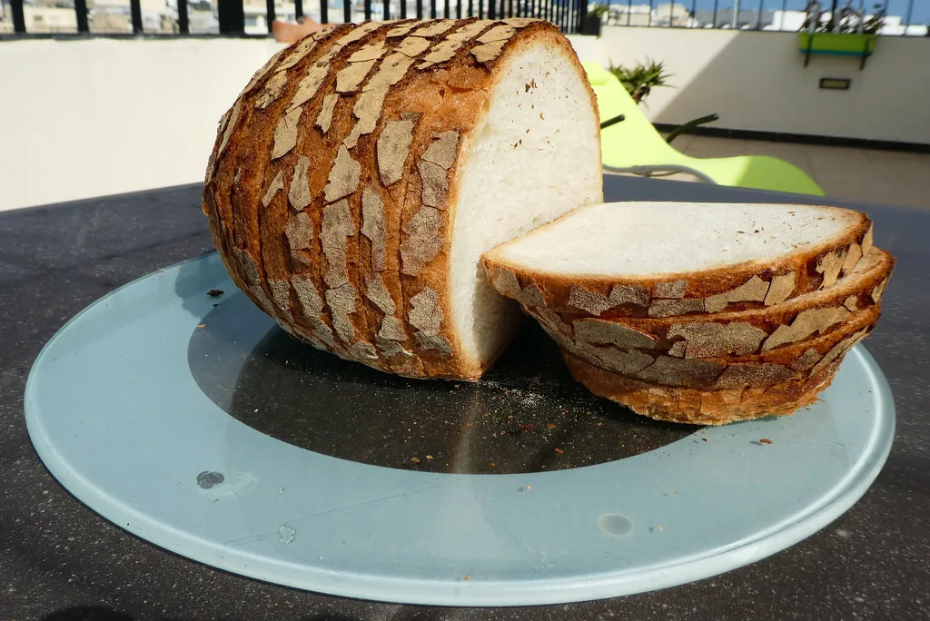 A Maltese loaf, ħobż tal-Malti, sliced.
