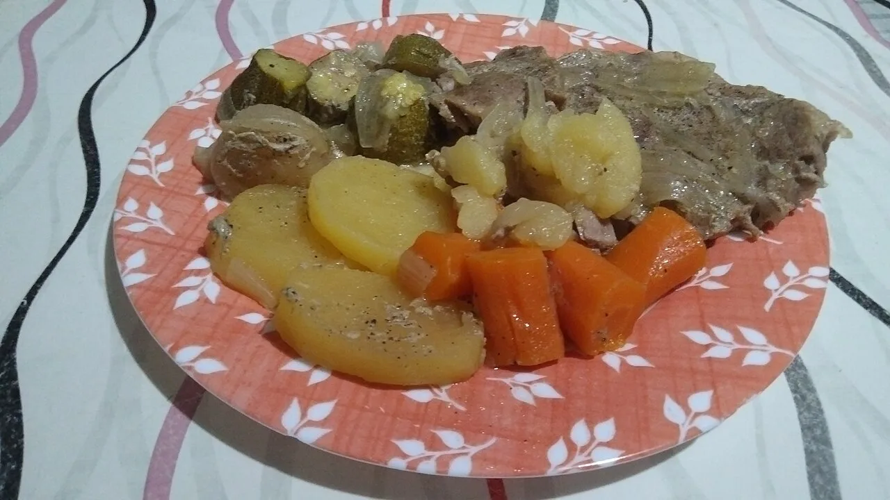 A home-cooked Maltese meal of meat with potatoes and carrots.