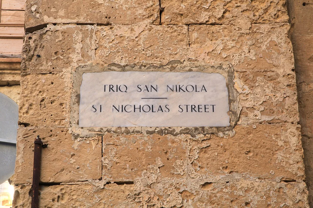 Triq San Nikola, a Maltese street name on a Valletta wall.