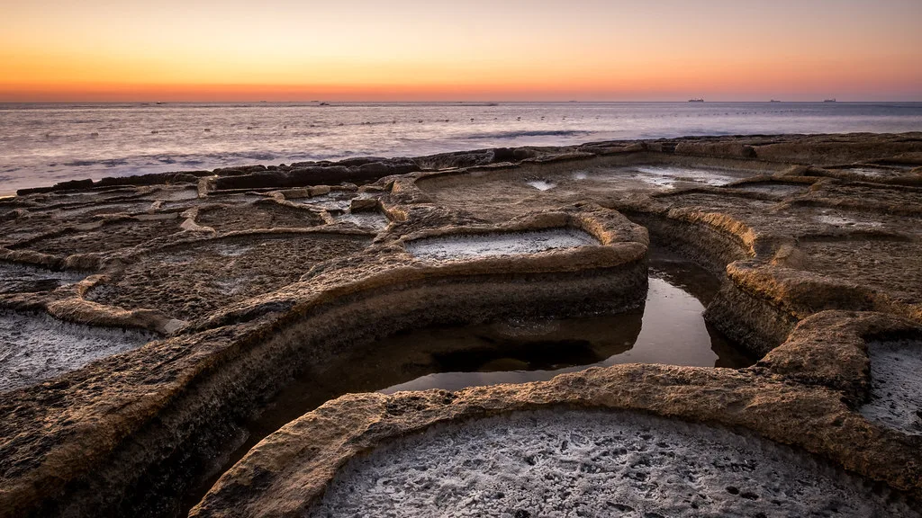 Rocky salt pans at Marsaskala at sunrise.