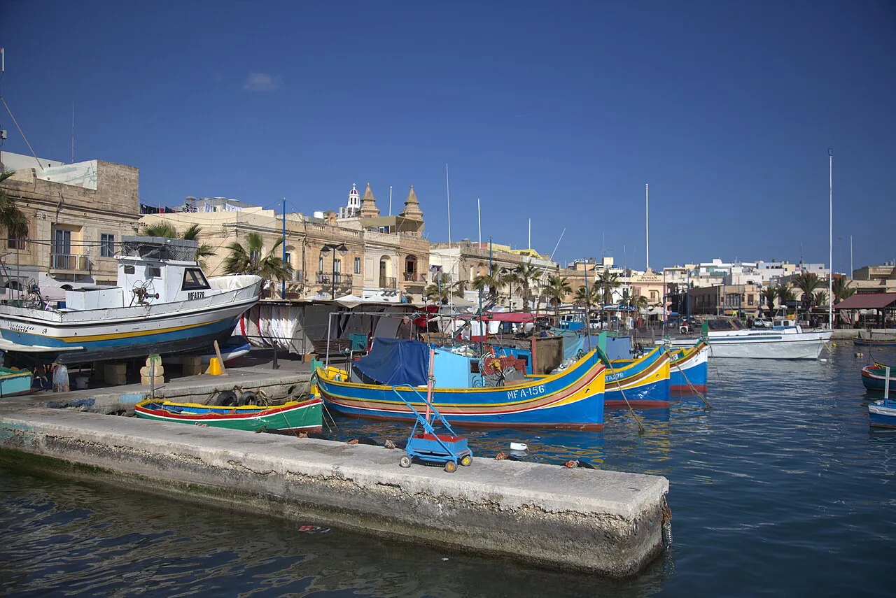 Colourful luzzu boats moored in Marsaxlokk harbour.