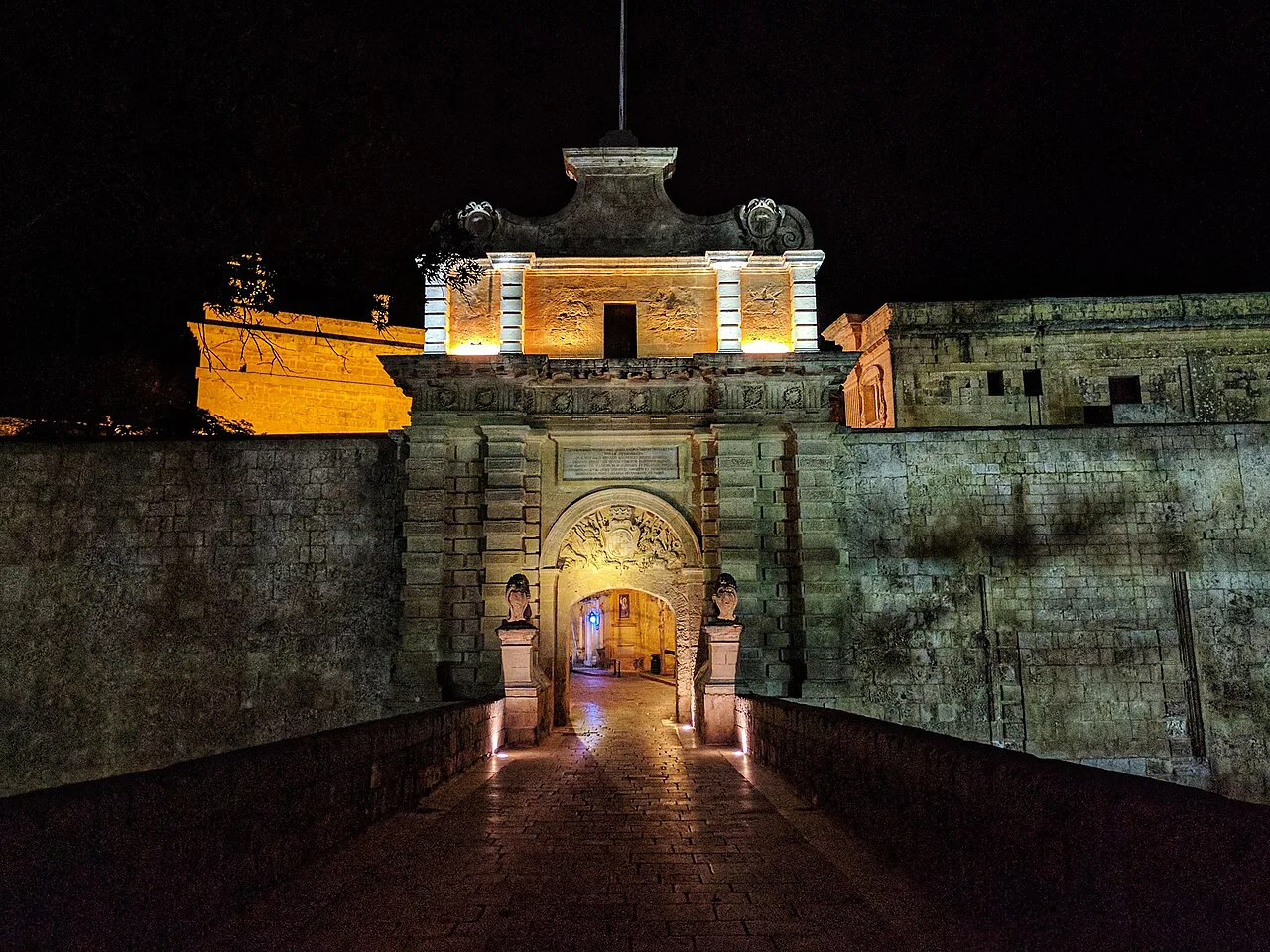 Mdina Gate lit up at night.