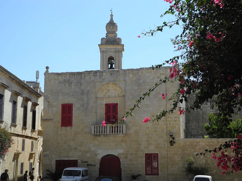 A quiet corner of Mdina with a small bell-gabled building.