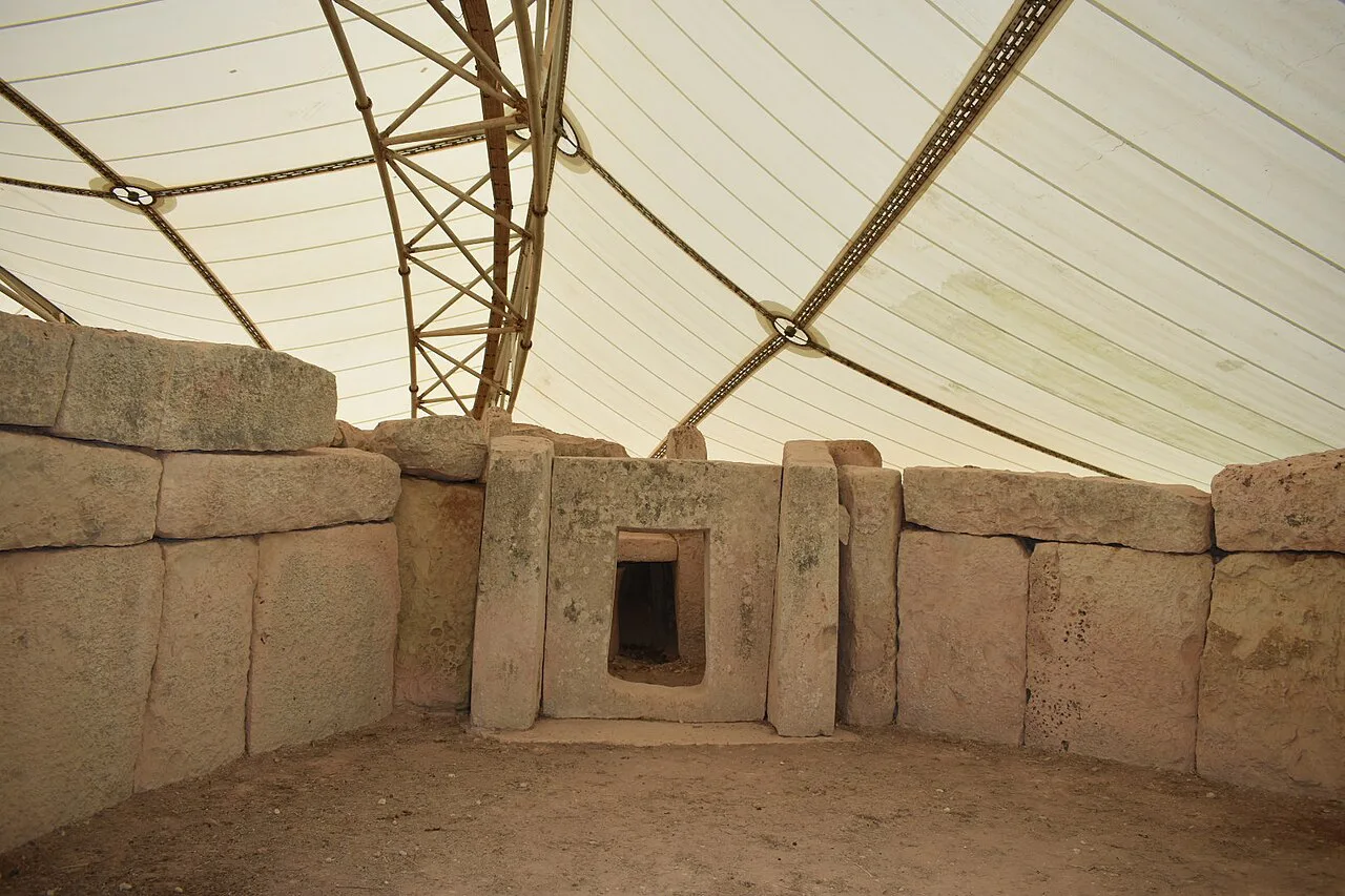 Stone chambers of Mnajdra temple, sheltered beneath a protective canopy.