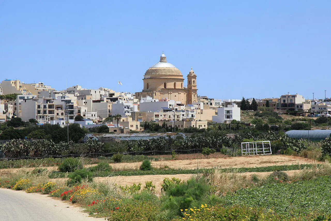 Mgarr's parish church rising above the village and fields.