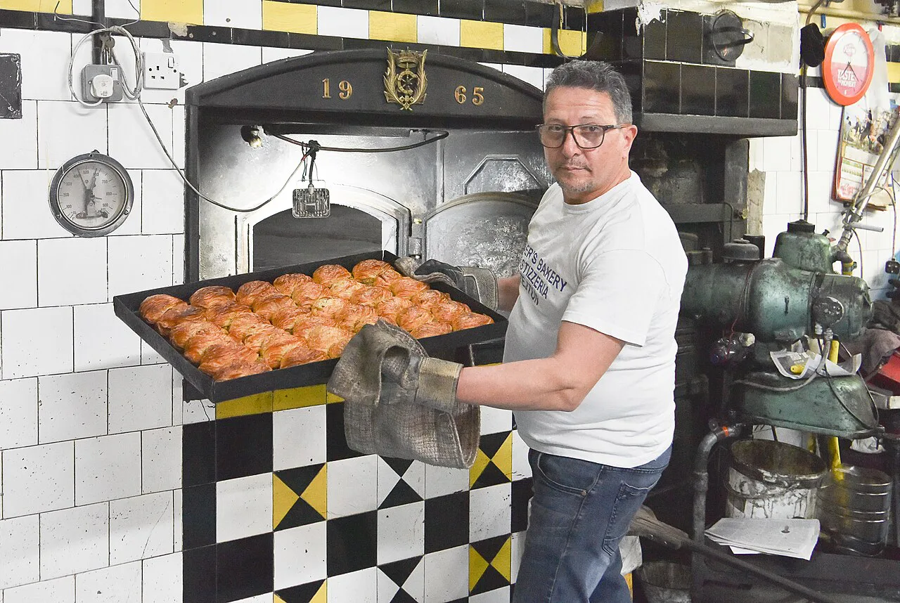 A tray of fresh pastizzi coming out of a Maltese bakery oven.