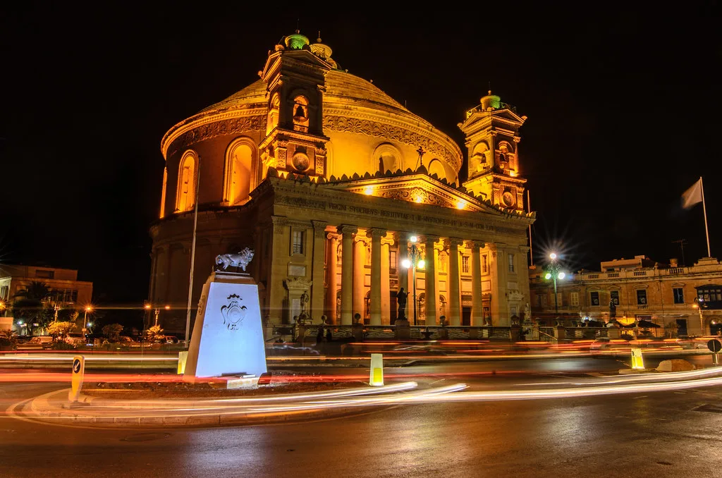 The Rotunda of Mosta lit up at night.