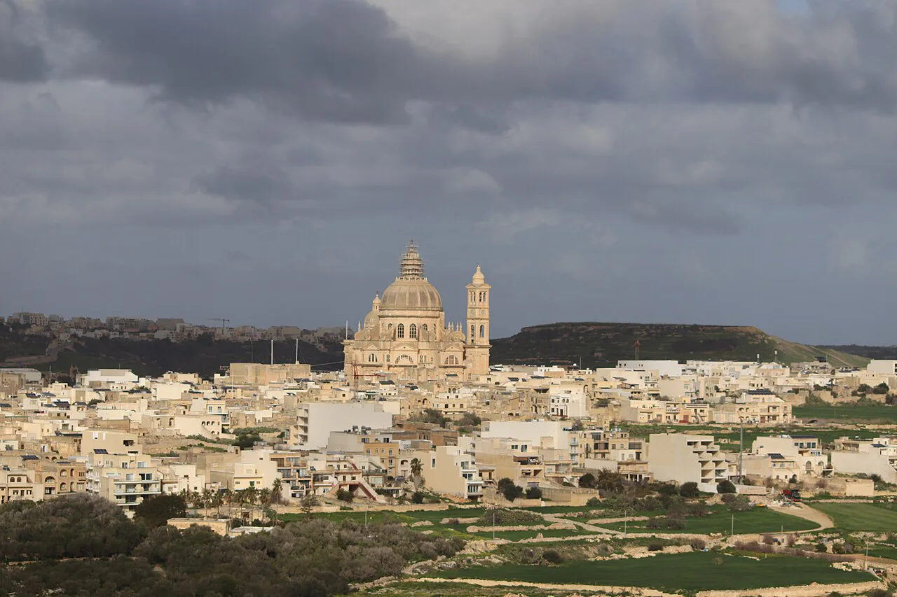 A view over Sannat on Gozo, with a domed church in the distance.