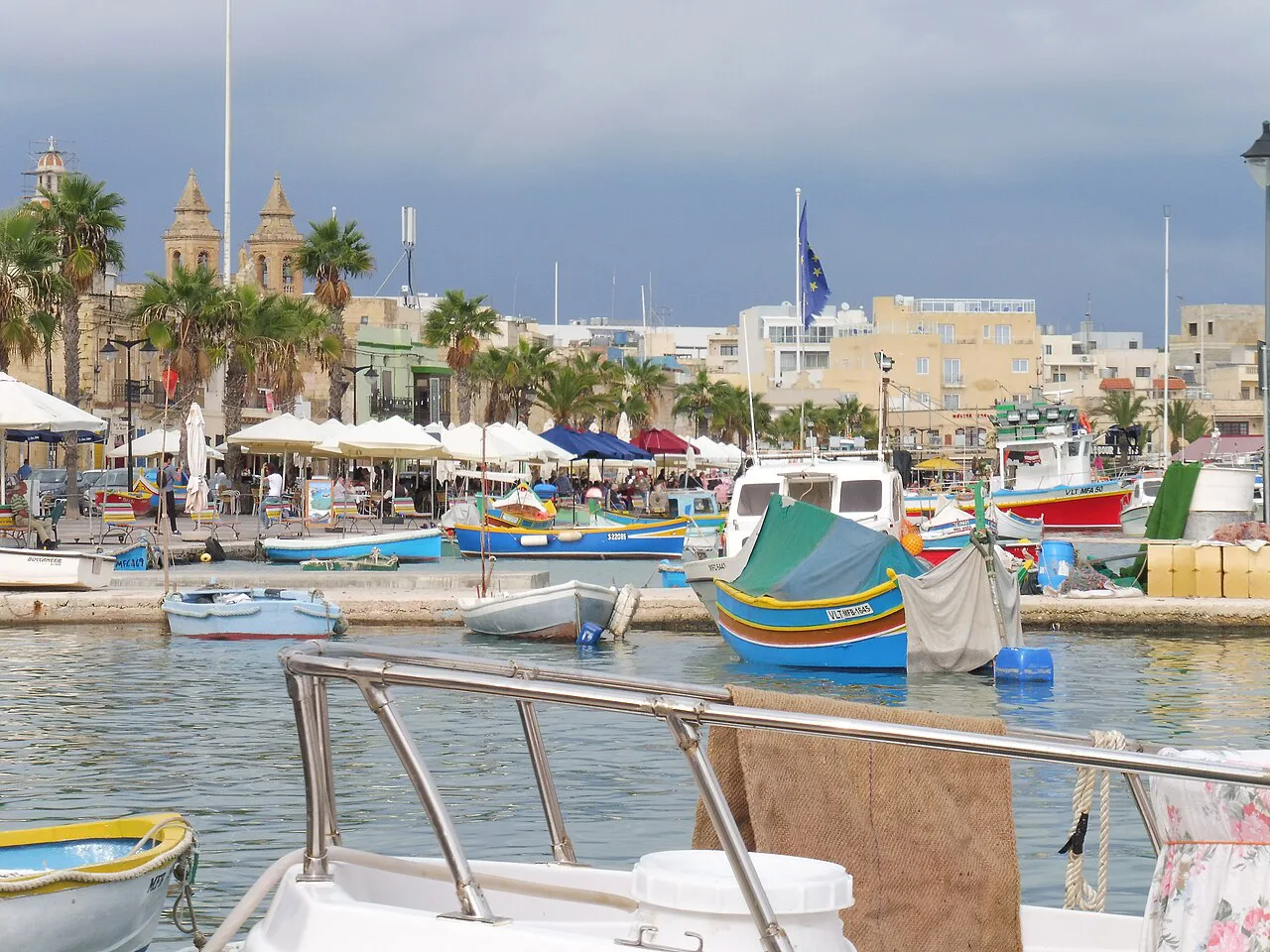 Luzzu boats and the waterfront in Marsaxlokk.