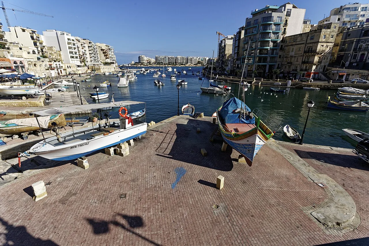 Luzzu boats and the quayside at Spinola Bay in St Julian's.