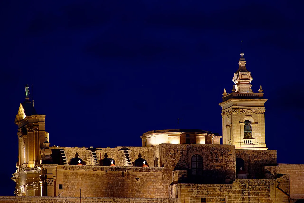 The Cittadella and Cathedral of the Assumption in Victoria, Gozo, lit at night.