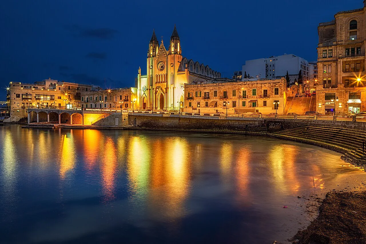 Balluta Bay and its church lit up at dusk.