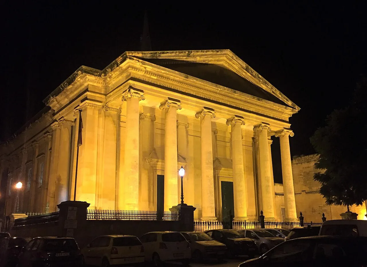 St Paul's Pro-Cathedral lit up at night in Valletta.