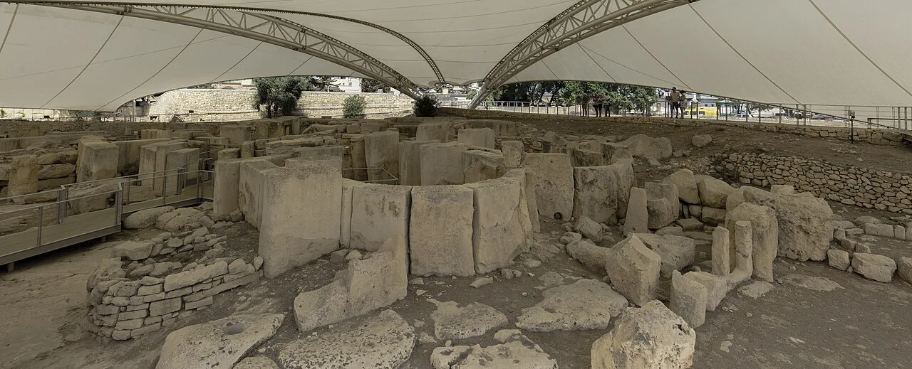 The temple remains at Tarxien under their protective canopy.