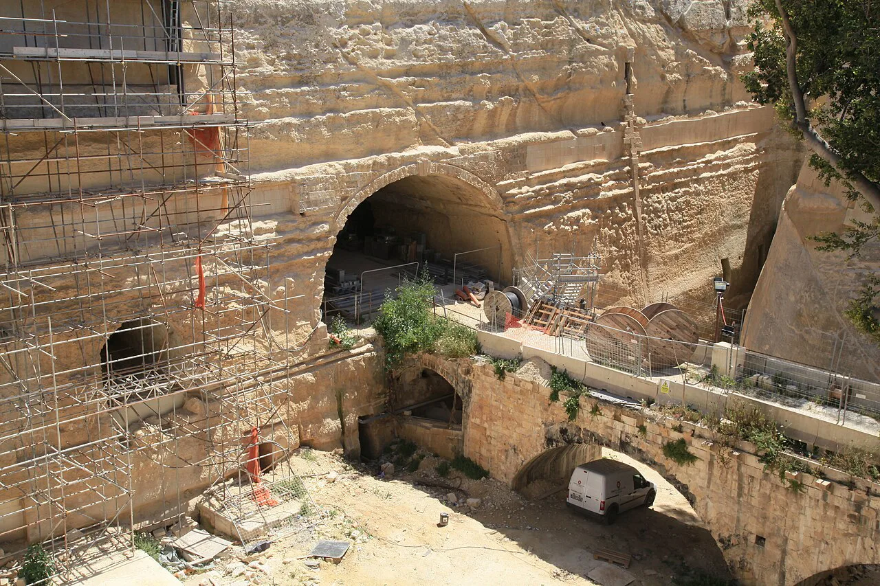 The ditch beside Valletta's City Gate, with its old railway tunnel and bridge.