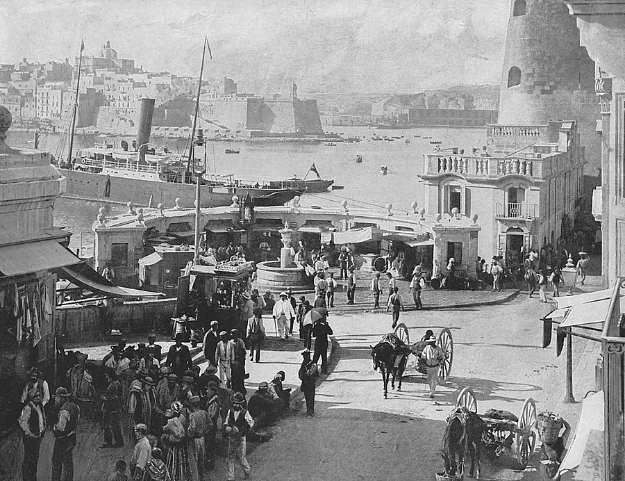 Fishing boats and stalls at the Valletta Marina fish market in an old photograph.