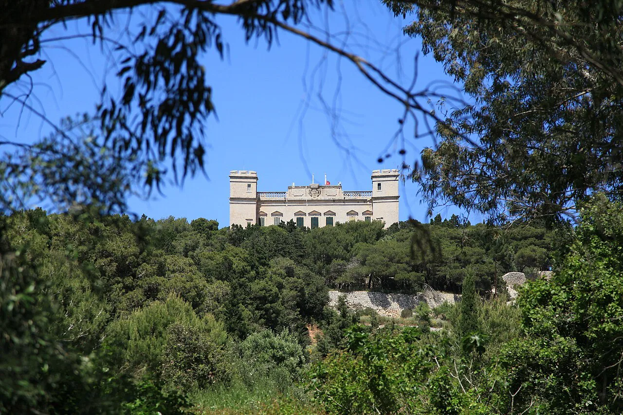 Verdala Palace seen through the trees of Buskett Gardens.