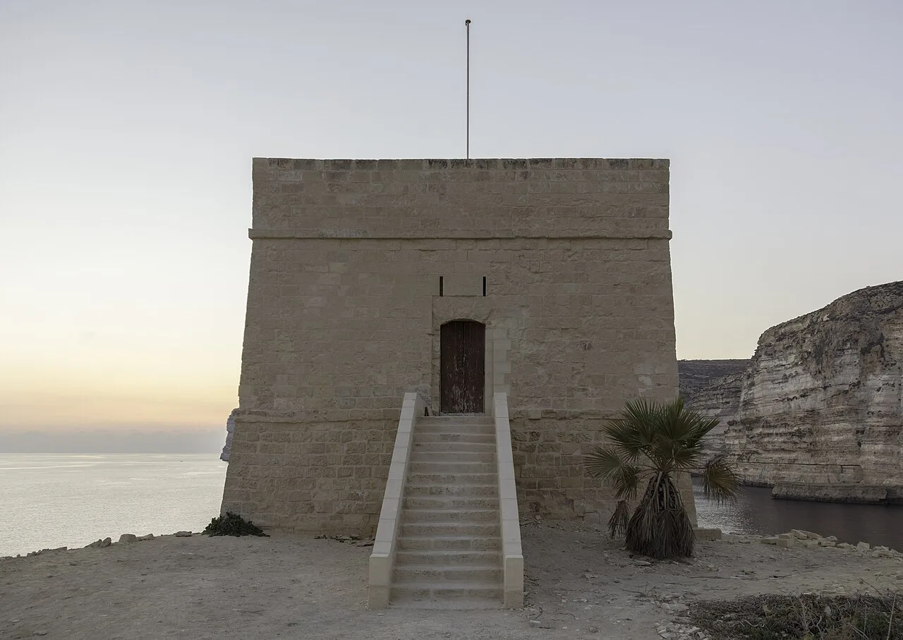 Xlendi Tower at sunset on Gozo's coast.